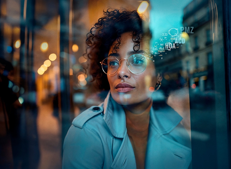 Woman wearing glasses with B.I.G. EXACT lenses from Rodenstock looking out of a window