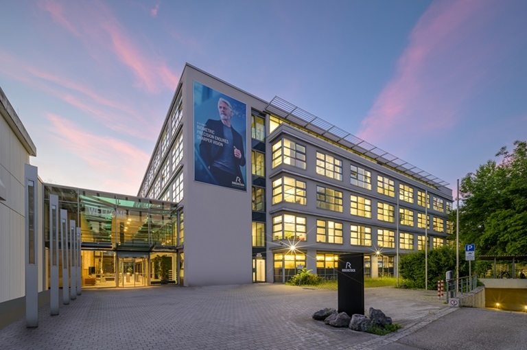 Illuminated Rodenstock headquarters in Munich at dusk